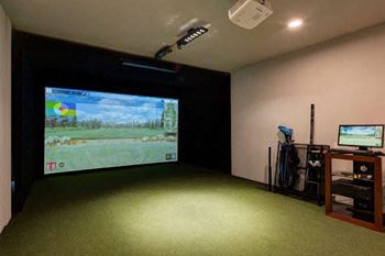 a room with a large projection screen and a television